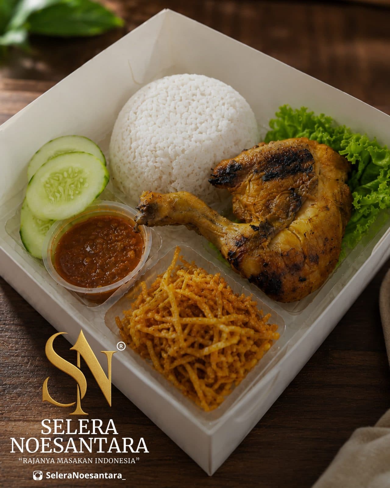 Nasi box berisi nasi, ayam, pelengkap, dan sambal